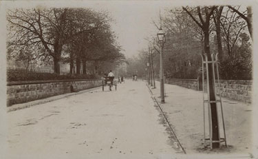 Unknown place: road with old wall and carriage