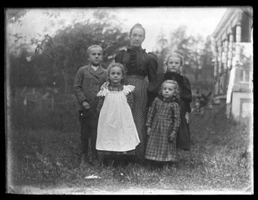 USA: Woman and four children full length family portrait