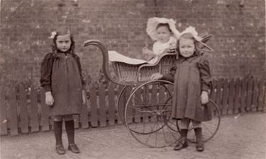 Unidentified group of children with pram