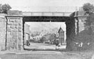 View: FD02468 Frodsham: Church Street.  Uphill view through Railway Bridge.  National School.