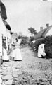 View: FD02478 Frodsham: Scene in London Road. Women outside cottages.