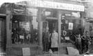 View: FD02769 Frodsham: Booth, Tom,  and daughter Jenny.  Outside his cycle shop.