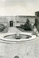 View: FD02848 Frodsham: Castle Park Gardens - Fountain in rose garden,   Peach houses in background.