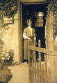 View: FD03086 Frodsham: Nellie Sutton at front door of Overton Cottage.