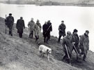 View: FD03284 Frodsham: Group of wildfowlers walking along bank of Ship Canal.  