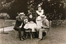 View: FD03668 Frodsham: A posed picture of Ladies and Gentleman taking tea in garden, maid waiting on.