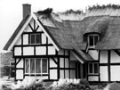 View: c05324 Whitegate: Thatching in progress on a property in the village
