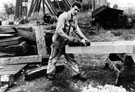 View: c06988 Northwich: Shipwright planing timber at Yarwood's shipyard 	