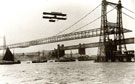 View: c11184 Widnes: Aeroplane over the Transporter Bridge