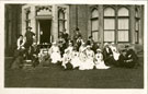 View: c12605 Nurses and civilians in group photograph at unknown location