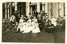 View: c12606 Nurses and civilians in group photograph at unknown location
