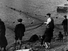 View: p0240 Fishermen bringing in a net watched by some boys on River Dee still from Chester Historic film 'Chester' 1933