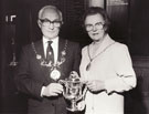 View: p1090 Mayor and Mayoress holding Trophy Cup presented by the Cheshire and Caernarfon Artillery, 750th anniversary exhibition