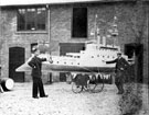 View: p1762 Two men with model ships mounted on bicycles or tricycles for a parade