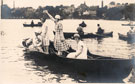 View: p2245 Four ladies in a boat on the river Dee, including Emily Davies standing with the chequered dress.