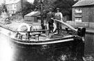 View: p2842 Chester Canal, two men at the tiller of a flat boat