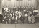 View: p4077 Black and white photograph of the Brookhirst Switchgear Choir rehearsing in the Pillar Hall